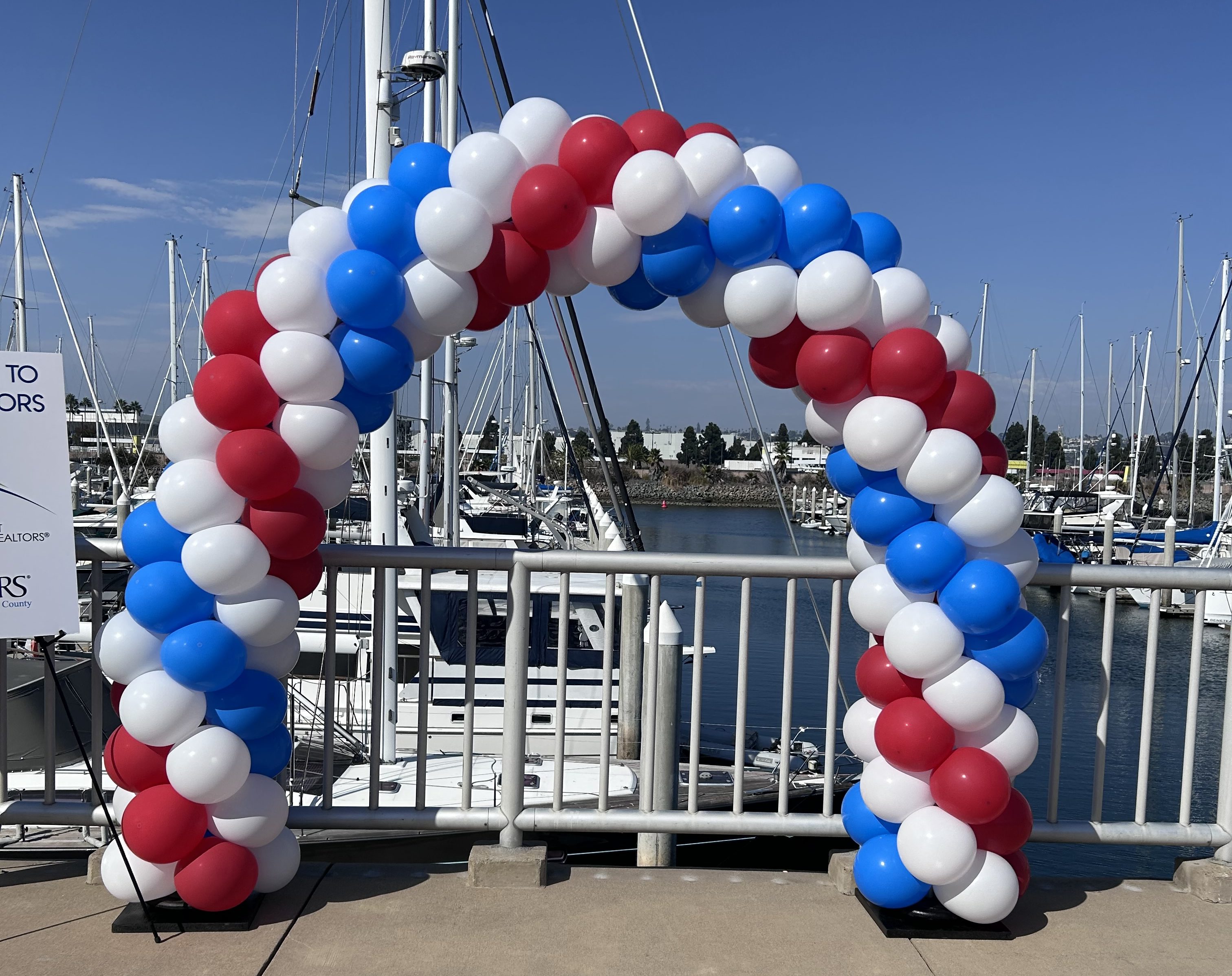 Outdoor wedding aisle with balloon arch
